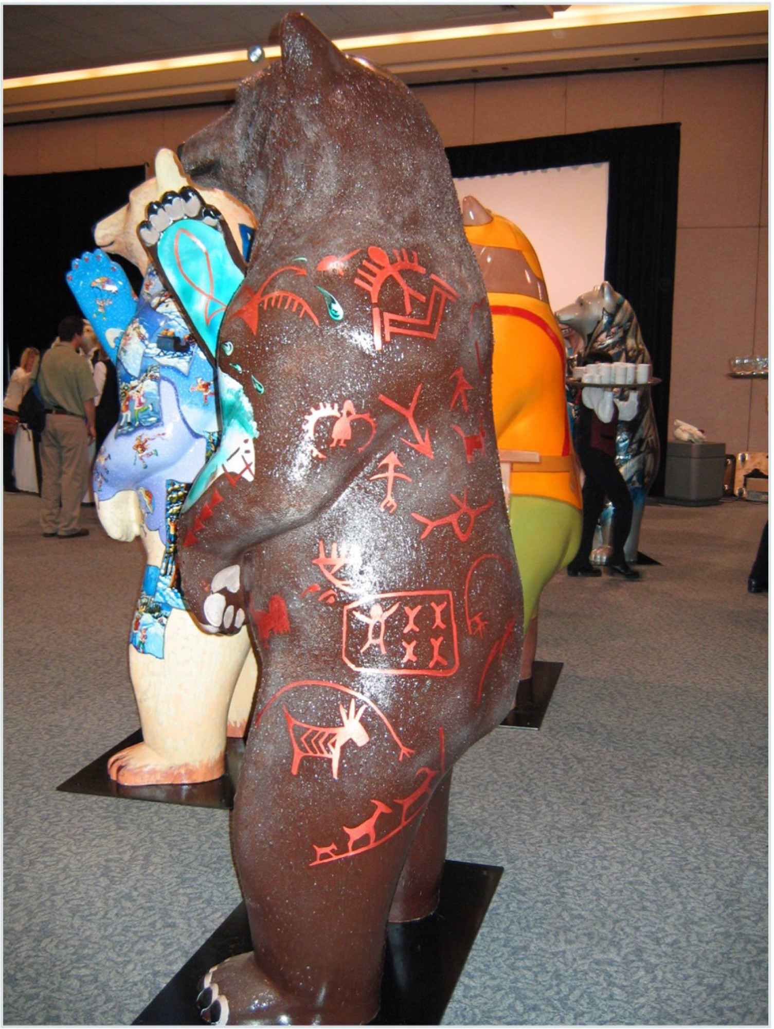 Back of the bear covered in red pictographic marks