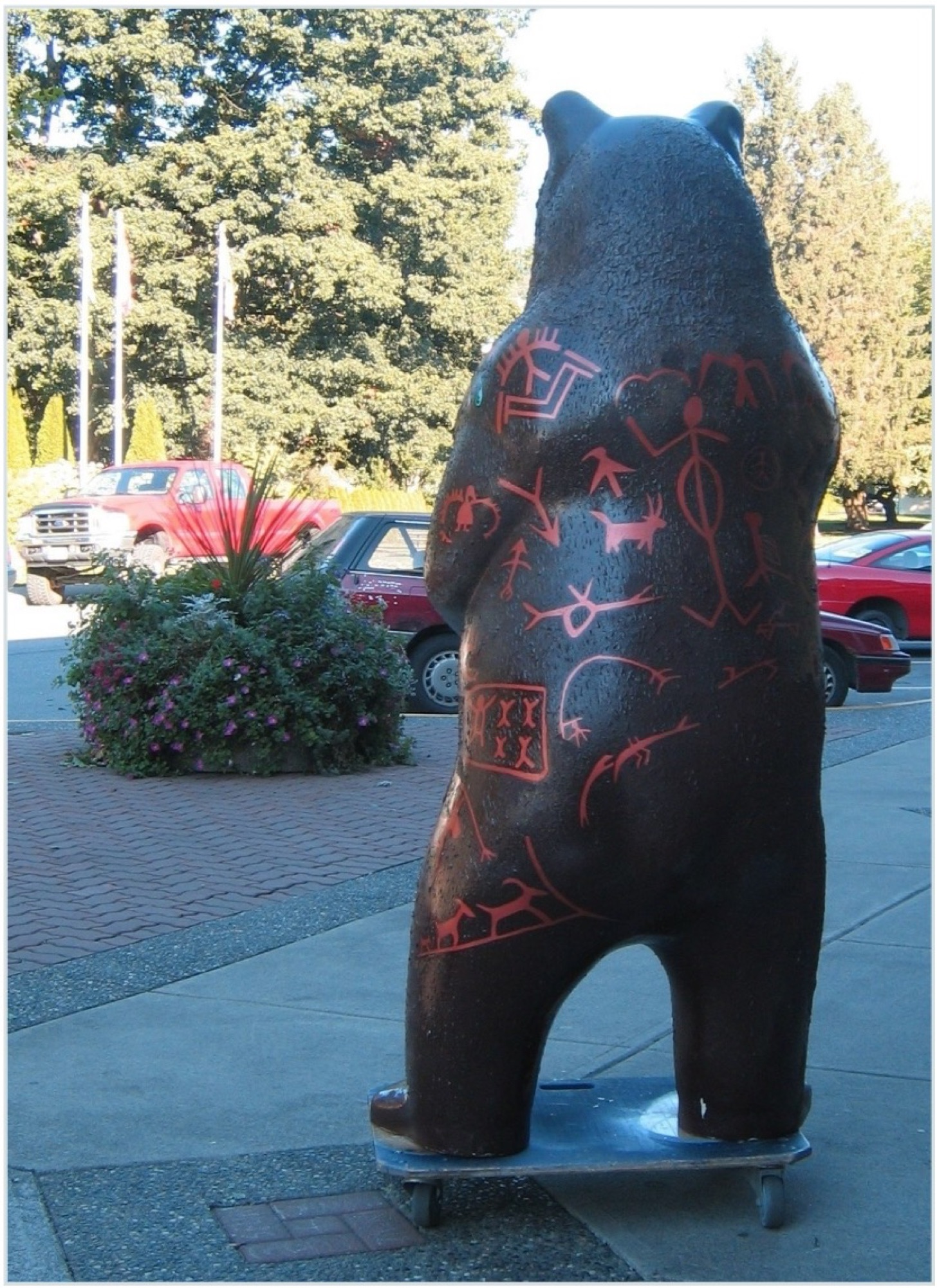 The bear outdoors on a wheeled base before installation