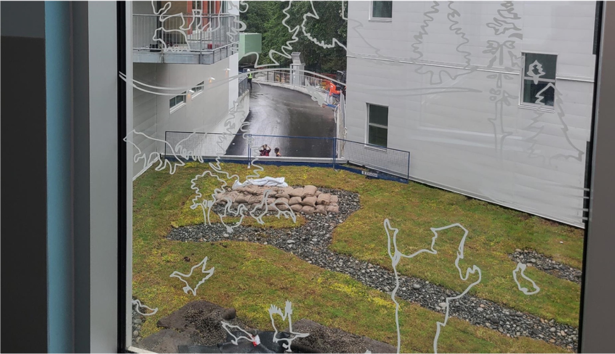 Birds and figures drawn over the courtyard path